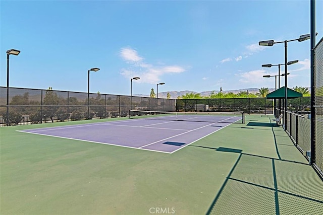 view of sport court featuring basketball court and a mountain view