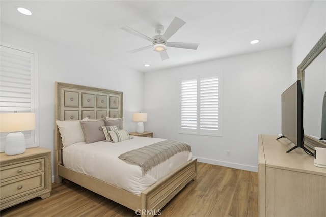 bedroom with ceiling fan and light hardwood / wood-style flooring