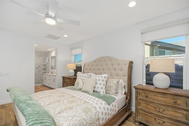 bedroom with ensuite bath, ceiling fan, and light wood-type flooring