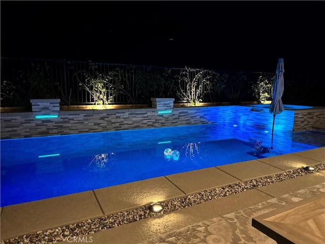 view of pool at night