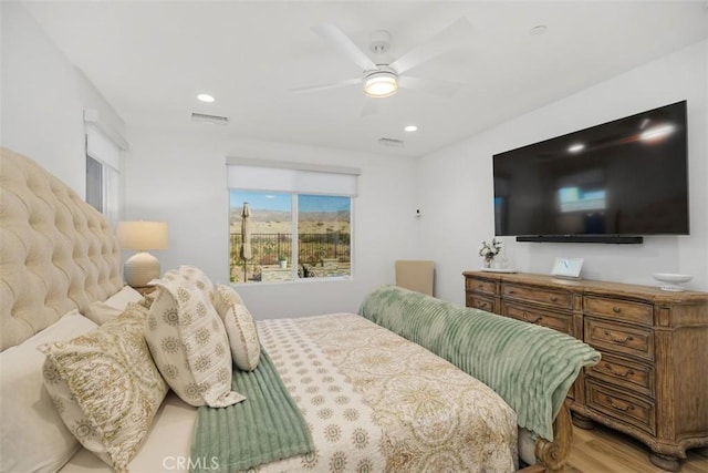 bedroom with light hardwood / wood-style floors and ceiling fan