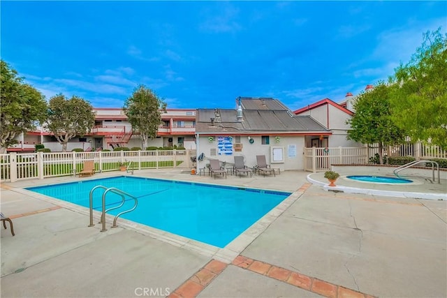 view of pool with a patio and a hot tub