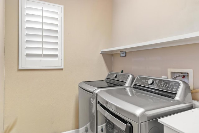 washroom featuring washing machine and clothes dryer