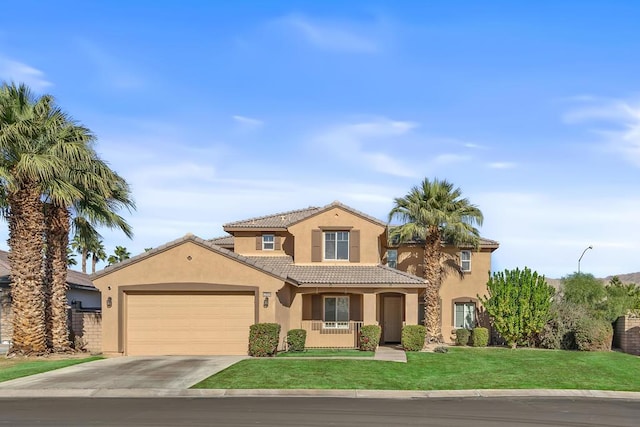 mediterranean / spanish home with a front yard and a garage