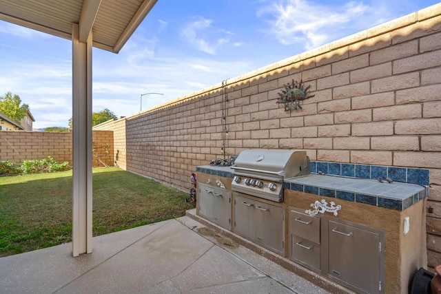 view of patio with area for grilling and exterior kitchen