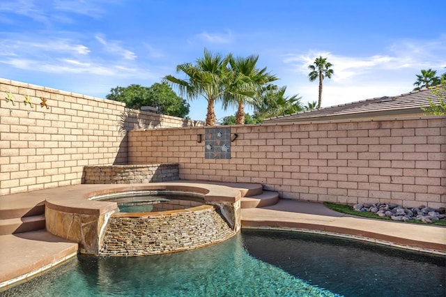 view of pool featuring an in ground hot tub