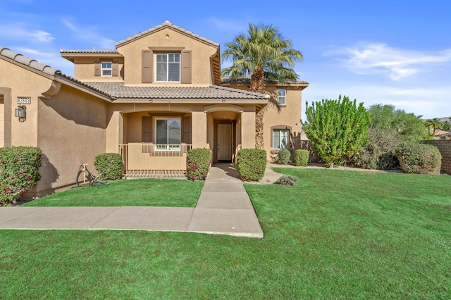 mediterranean / spanish-style house with a front yard