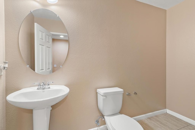 bathroom with tile patterned floors, sink, and toilet