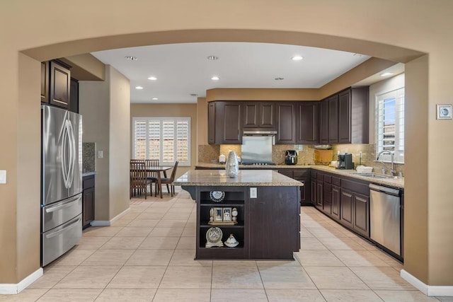 kitchen featuring a center island, stainless steel appliances, plenty of natural light, and sink