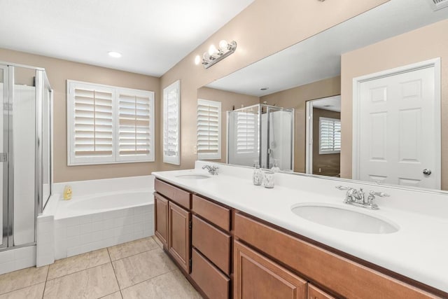 bathroom with tile patterned floors, vanity, and separate shower and tub