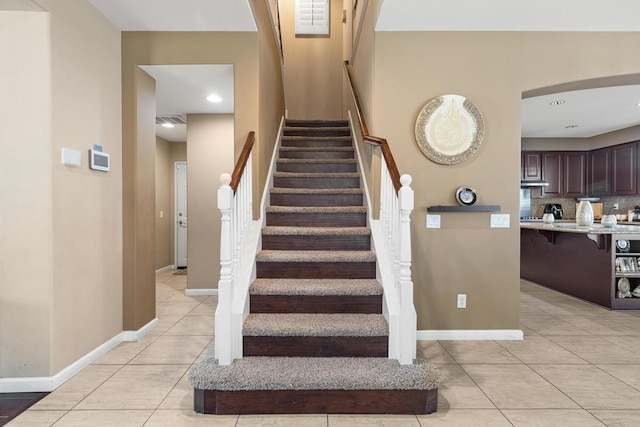 stairs with tile patterned floors