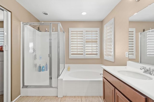 bathroom with tile patterned flooring, vanity, and independent shower and bath