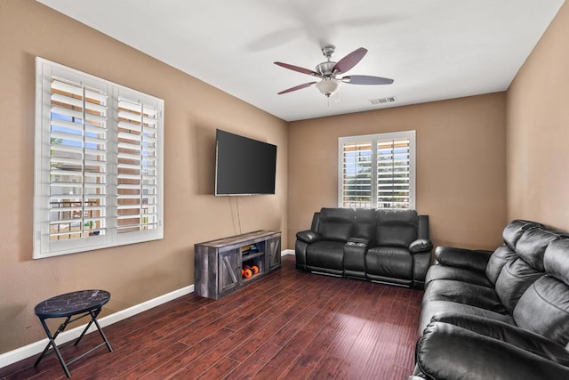 living room with ceiling fan and dark wood-type flooring