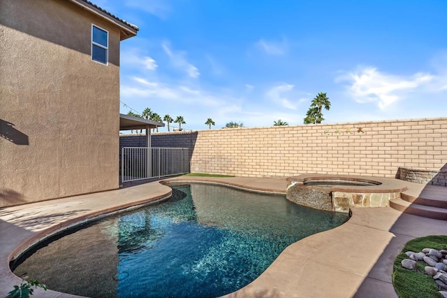 view of swimming pool with an in ground hot tub