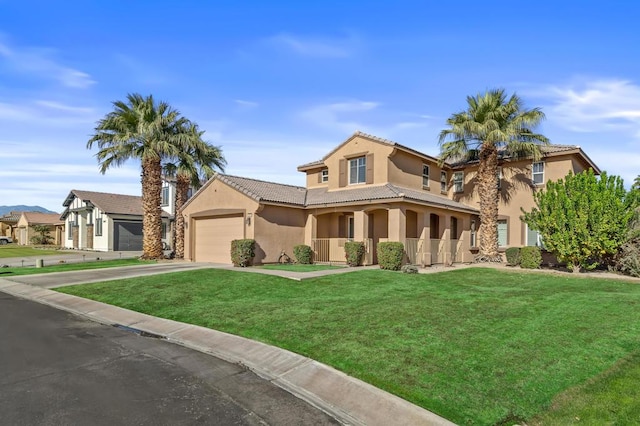 mediterranean / spanish-style house featuring a front yard, a porch, and a garage