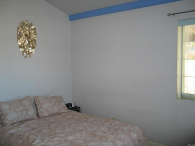 bedroom featuring vaulted ceiling