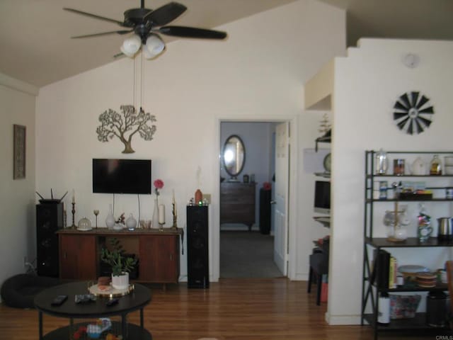 living room featuring dark wood-type flooring, ceiling fan, and lofted ceiling