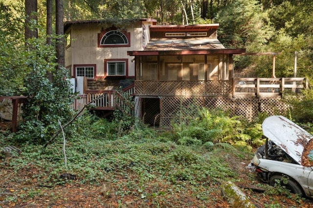 rear view of property with a wooden deck