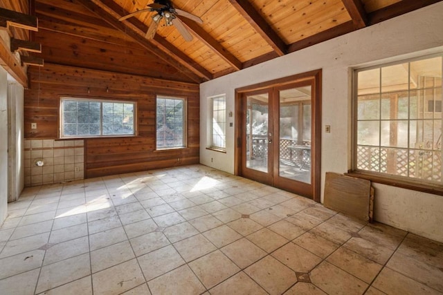 unfurnished sunroom with vaulted ceiling with beams, ceiling fan, wood ceiling, and french doors