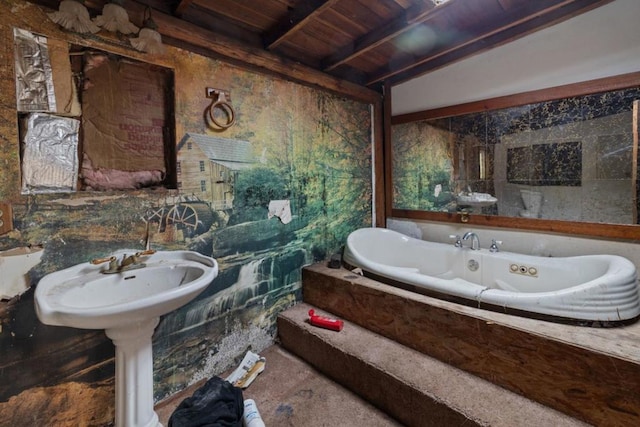 bathroom with tiled bath, wooden ceiling, and vaulted ceiling with beams