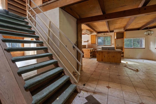 stairs featuring a chandelier, tile patterned flooring, and wooden ceiling