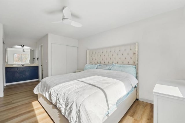 bedroom with a closet, ceiling fan, and light hardwood / wood-style flooring