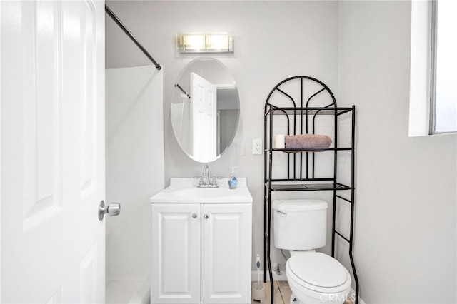 bathroom with vanity, toilet, and walk in shower