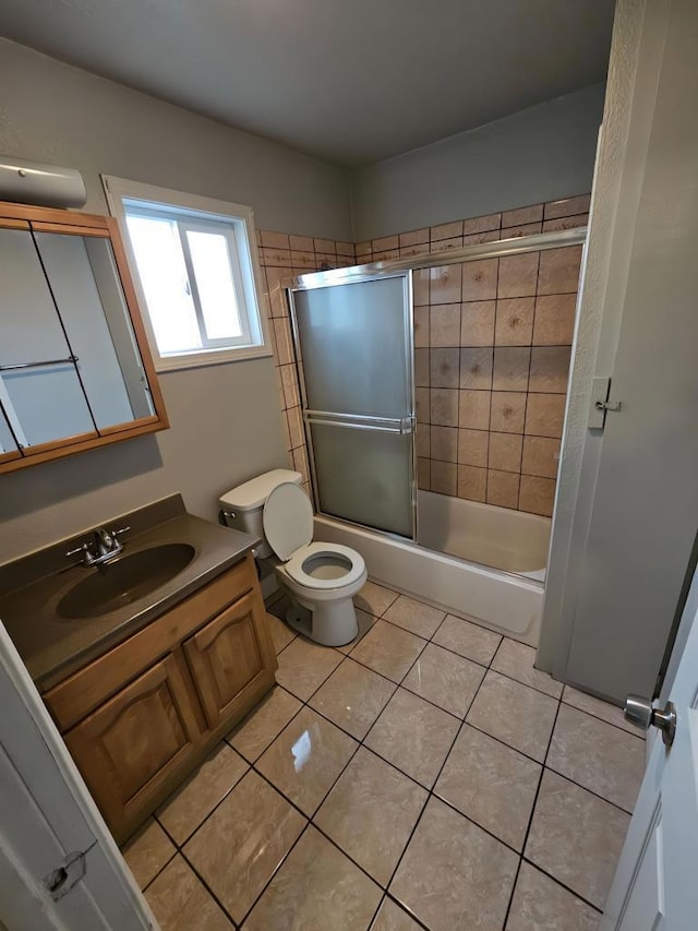 full bathroom with enclosed tub / shower combo, vanity, toilet, and tile patterned flooring