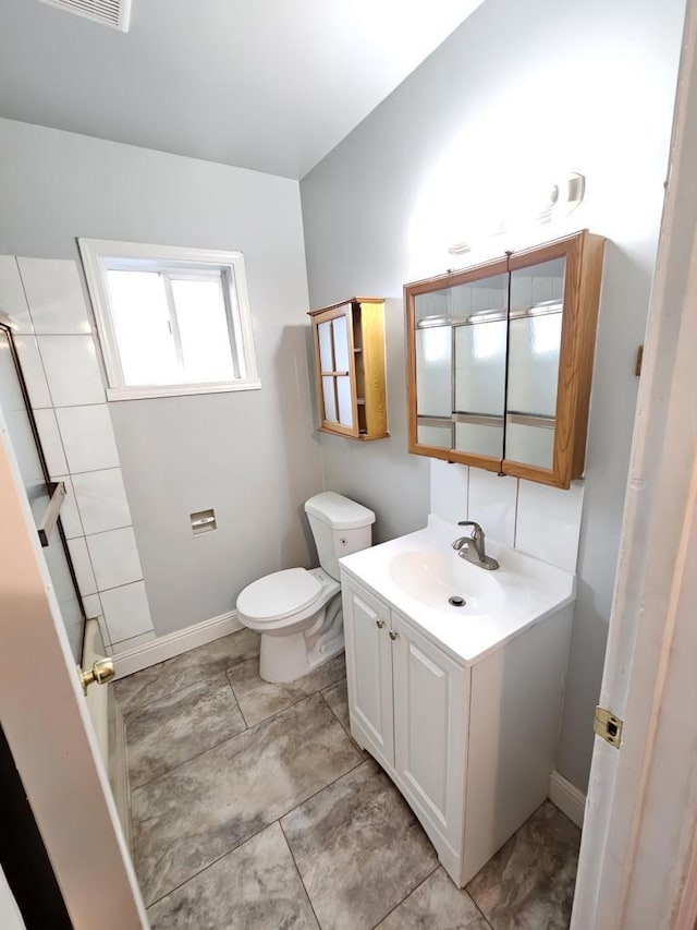 bathroom featuring toilet and vanity