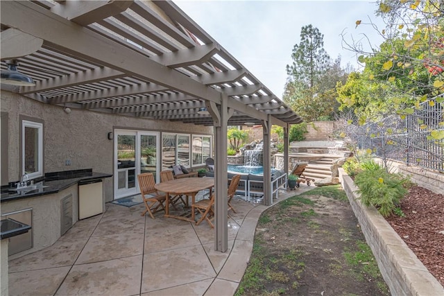 view of patio / terrace with a pergola, sink, and an outdoor kitchen