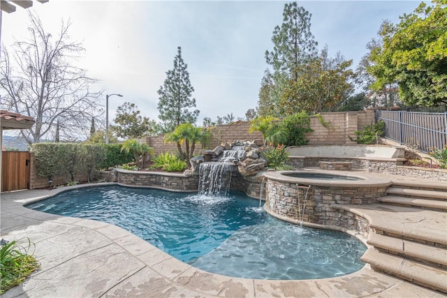 view of pool with an in ground hot tub and pool water feature