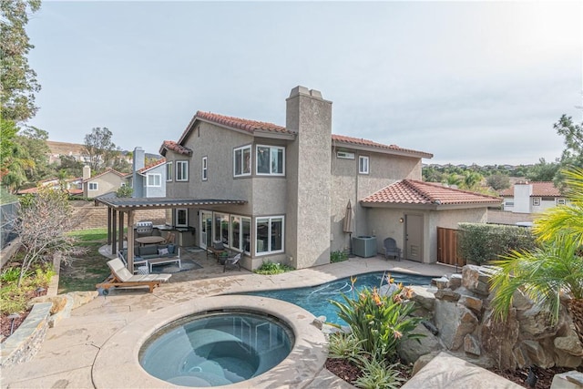 back of house featuring a swimming pool with hot tub, a patio area, a pergola, and cooling unit