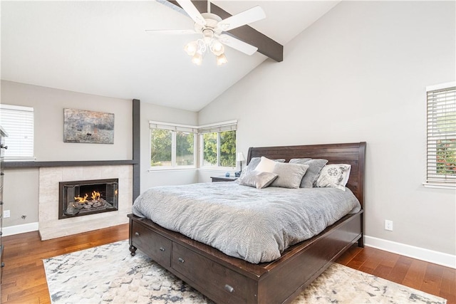 bedroom with multiple windows, ceiling fan, and dark hardwood / wood-style flooring