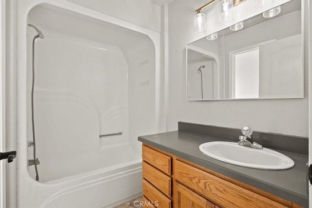 bathroom featuring bathing tub / shower combination and vanity