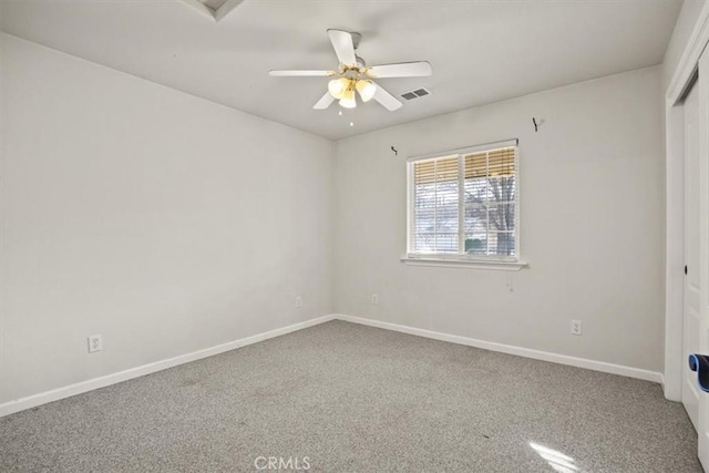 carpeted spare room with ceiling fan