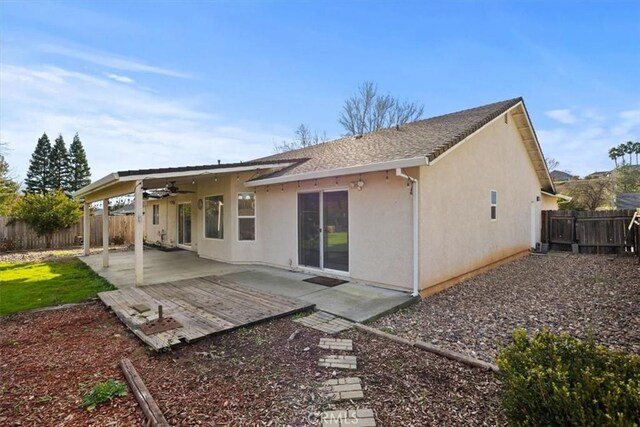 rear view of property featuring ceiling fan and a patio