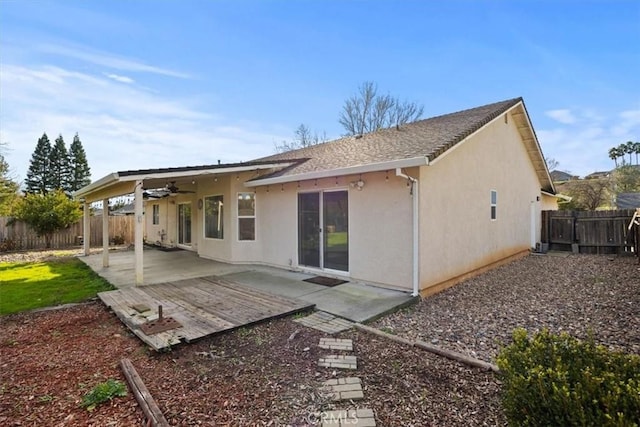 back of house featuring ceiling fan, stucco siding, a fenced backyard, and a patio area