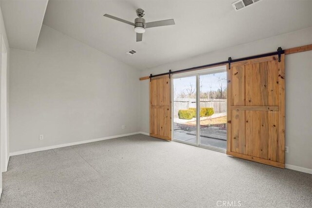 carpeted empty room featuring ceiling fan and lofted ceiling