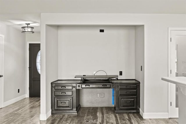 kitchen featuring wood finished floors and baseboards