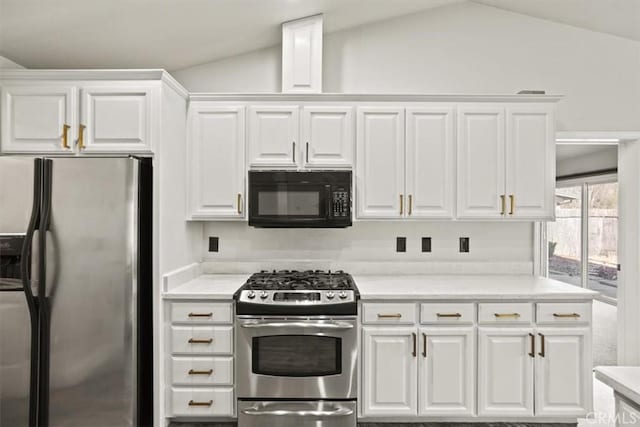 kitchen with white cabinetry, lofted ceiling, light countertops, and stainless steel appliances