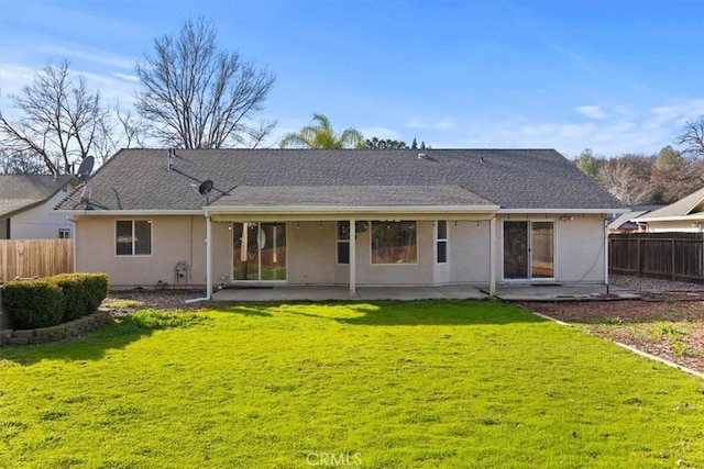 back of property with stucco siding, fence, and a patio area