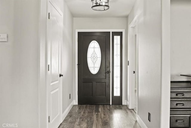 entryway featuring baseboards and wood finished floors