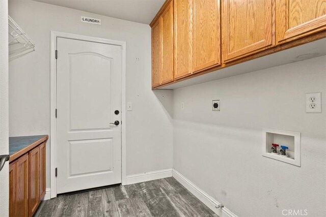 washroom with hookup for a washing machine, dark wood-type flooring, hookup for an electric dryer, gas dryer hookup, and cabinets