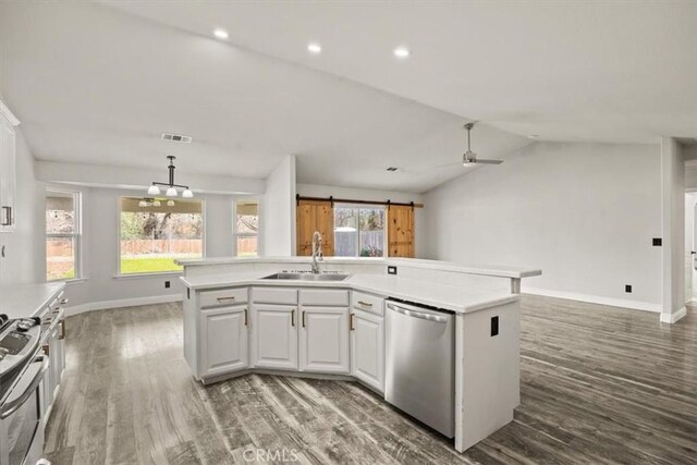 kitchen featuring an island with sink, ceiling fan, appliances with stainless steel finishes, white cabinets, and sink