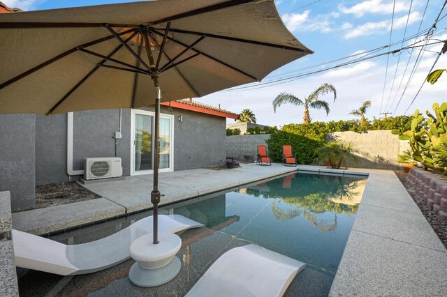 view of swimming pool featuring ac unit and a patio