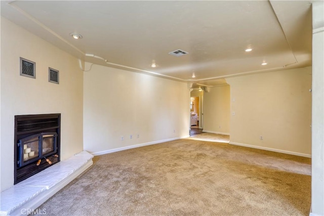 unfurnished living room featuring light colored carpet and ornamental molding