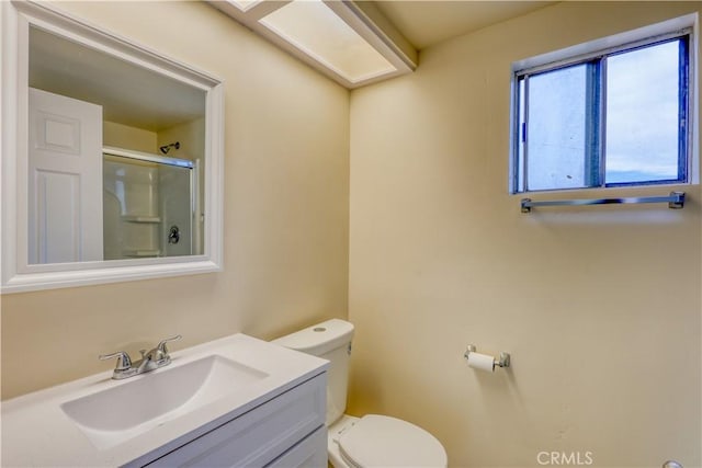 bathroom with vanity, an enclosed shower, and toilet