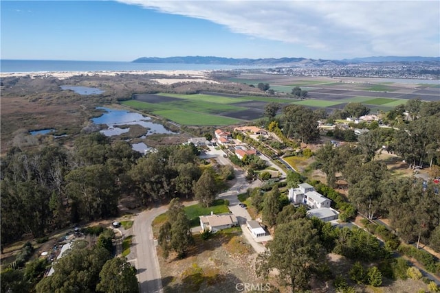 drone / aerial view with a water and mountain view