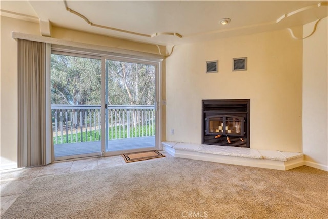 unfurnished living room featuring carpet flooring