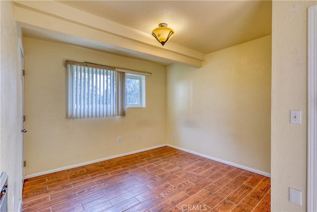 spare room featuring hardwood / wood-style floors